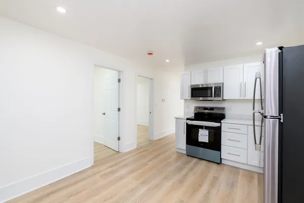 a kitchen with stainless steel appliances a refrigerator and a stove top oven