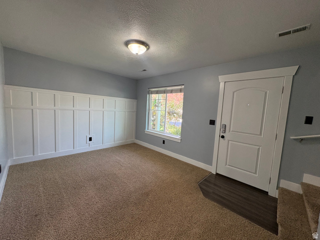 922 North 480 West Logan, UT 84321 - Photo 7 of 11 Entryway featuring board and batten wall paneling, light gray paint, and a window for natural illumination