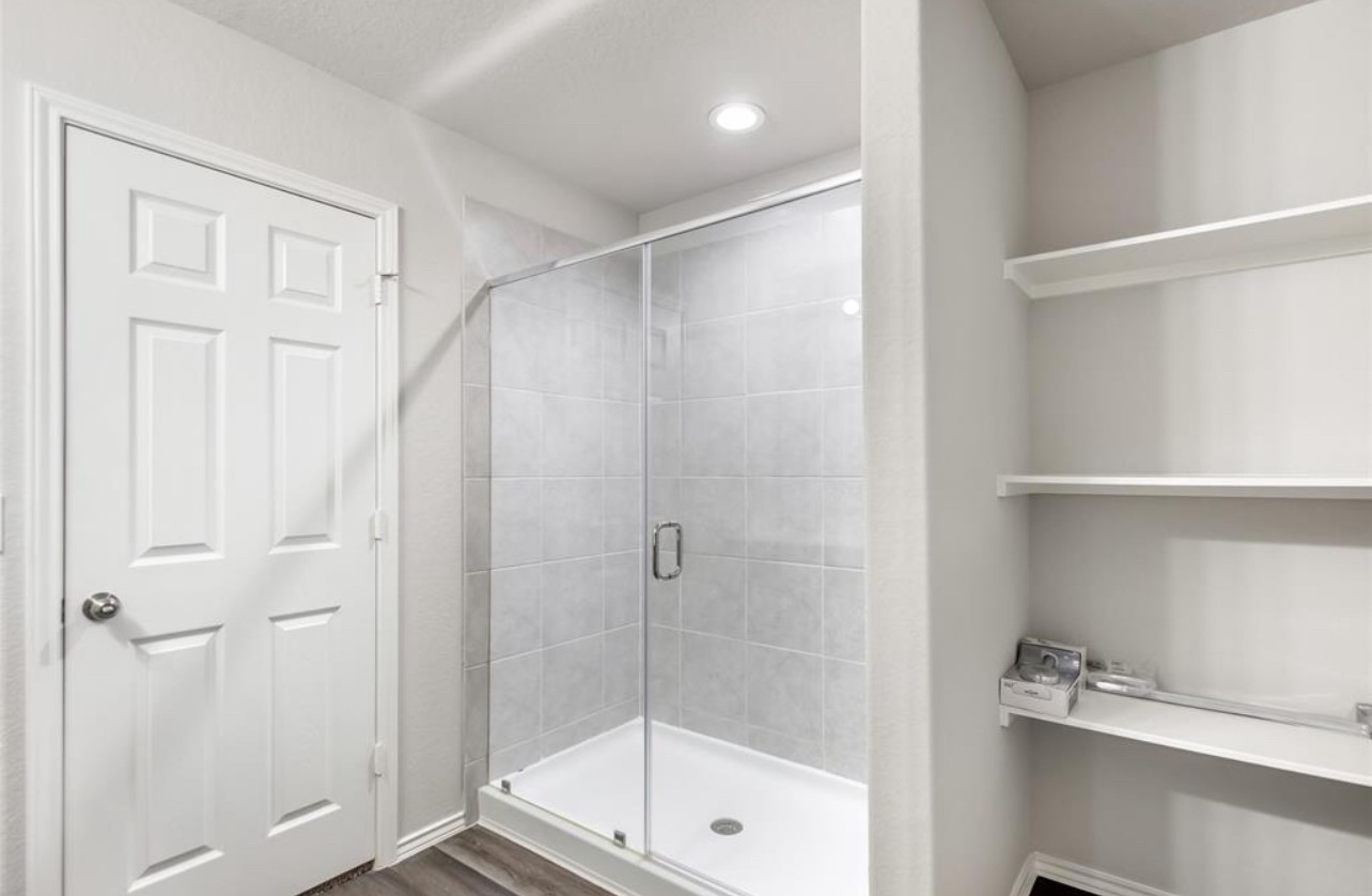 10031 Spring Creek Road Cleveland, TX 77327 - Photo 15 of 18 a bathroom with a shower