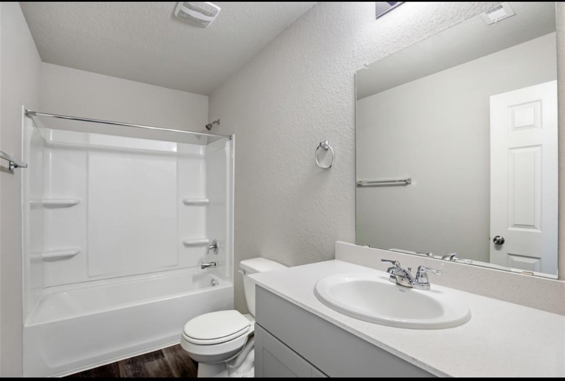 10031 Spring Creek Road Cleveland, TX 77327 - Photo 17 of 18 a bathroom with a sink toilet and shower