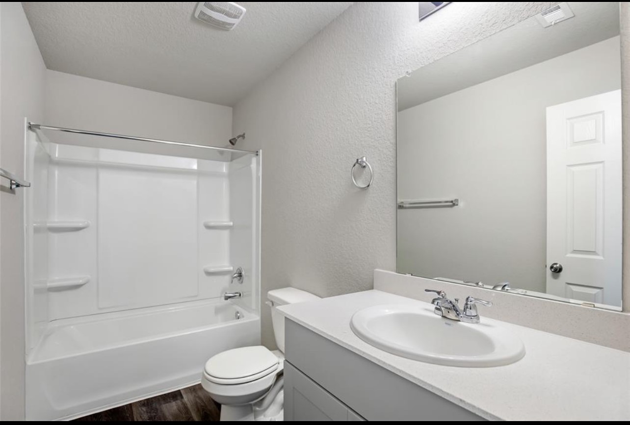 10031 Spring Creek Road Cleveland, TX 77327 - Photo 17 of 18 a bathroom with a sink toilet and shower