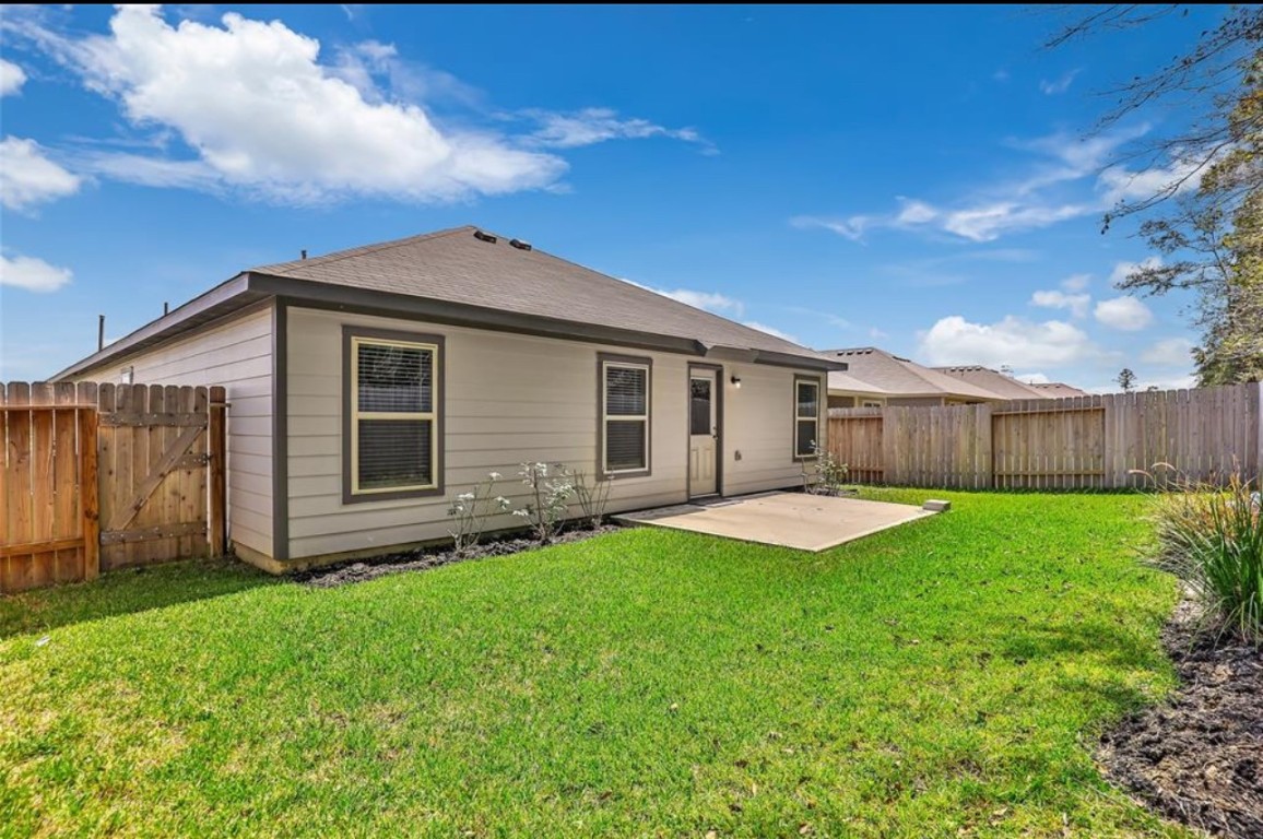 10031 Spring Creek Road Cleveland, TX 77327 - Photo 5 of 18 a view of a yard with a house