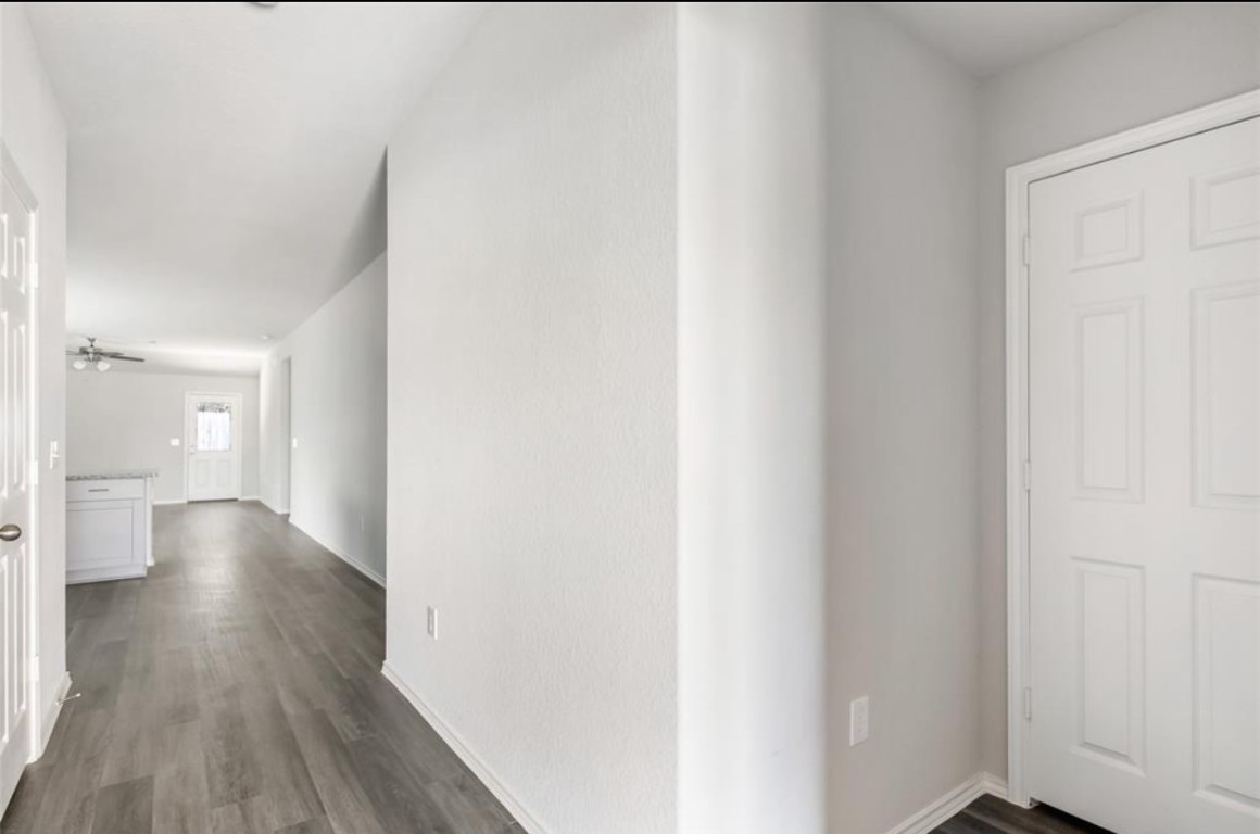 10031 Spring Creek Road Cleveland, TX 77327 - Photo 6 of 18 a view of a hallway with wooden floor
