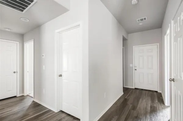 a view of hallway with wooden floor