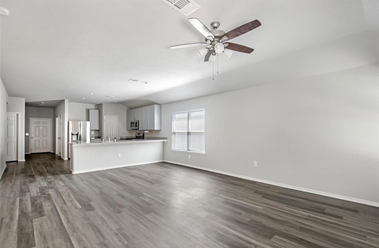 10031 Spring Creek Road Cleveland, TX 77327 - Photo 9 of 18 a view of a kitchen with wooden floor and a window