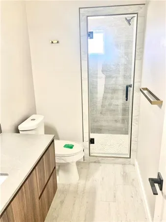 a bathroom with a shower a toilet and a shower