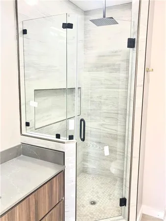 a bathroom with a shower and a sink