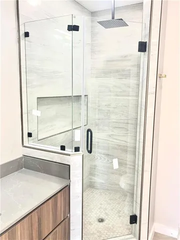 a bathroom with a shower and a sink