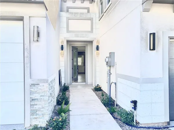 a hallway with white walls and a fireplace