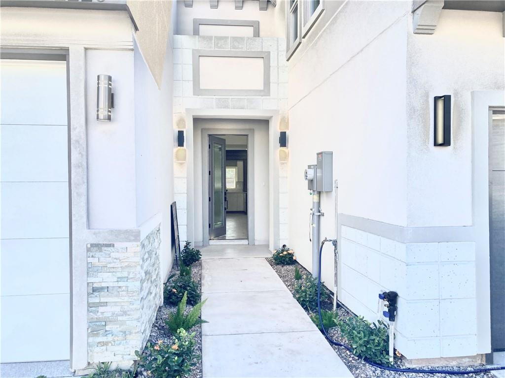 2218 Corales Street Mission, TX 78573 - Photo 3 of 22 a hallway with white walls and a fireplace