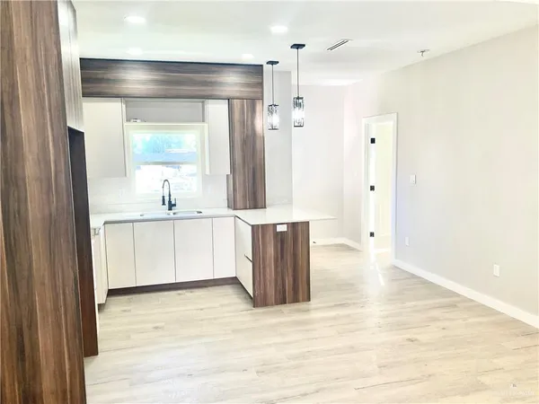 a bathroom with a double vanity sink a mirror and a shower