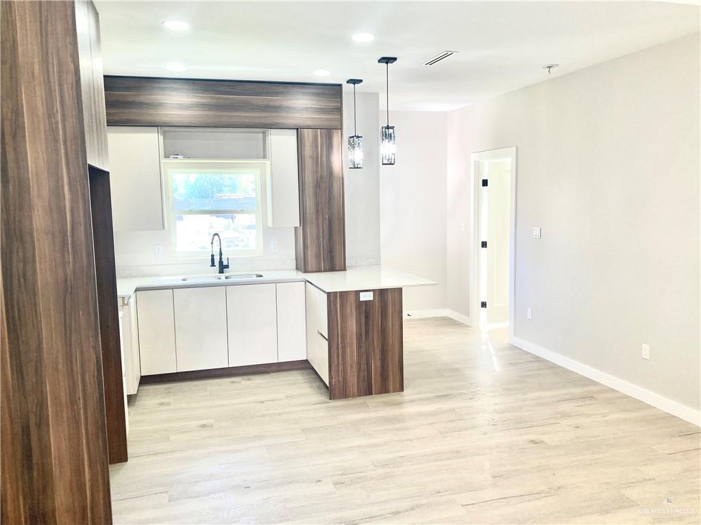 2218 Corales Street Mission, TX 78573 - Photo 5 of 22 a bathroom with a double vanity sink a mirror and a shower