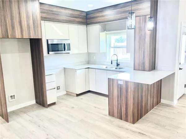 a kitchen with stainless steel appliances granite countertop a coffee maker a sink and a refrigerator