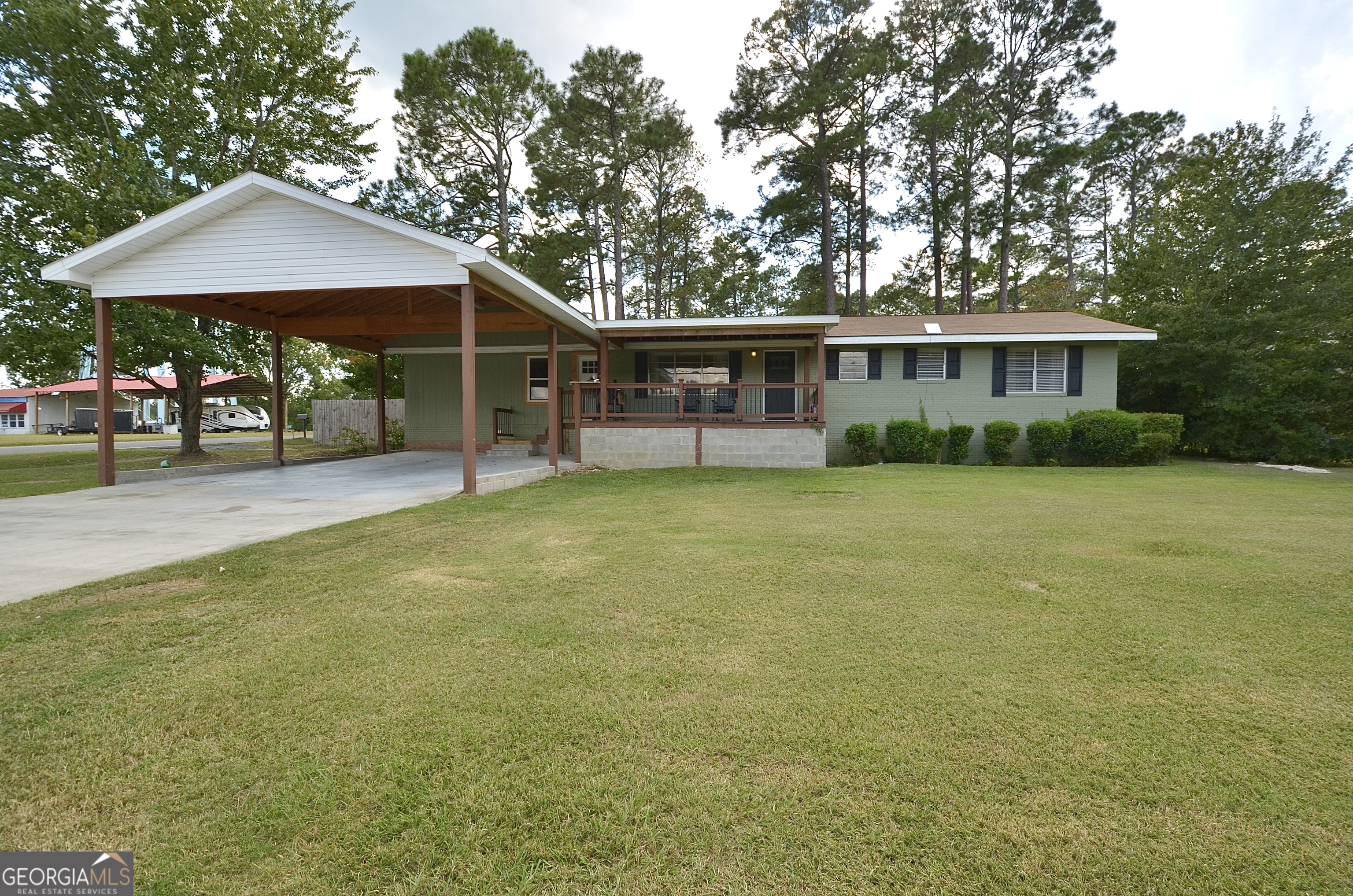 a view of a house with a yard and sitting area