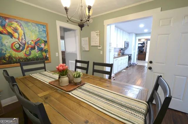 a view of a dining room with furniture and a chandelier