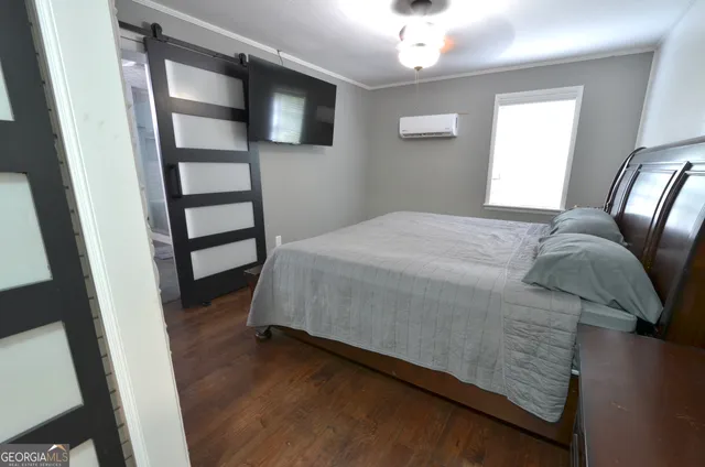 a bed sitting in a bedroom next to a window