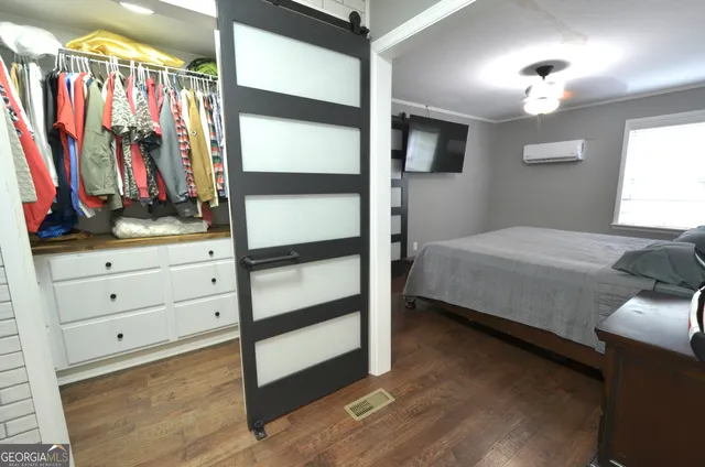 a bedroom with a bed and a walk in closet