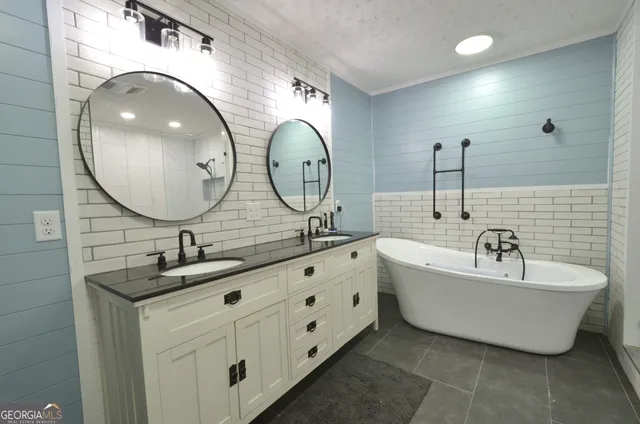 a bathroom with a double vanity sink and a mirror