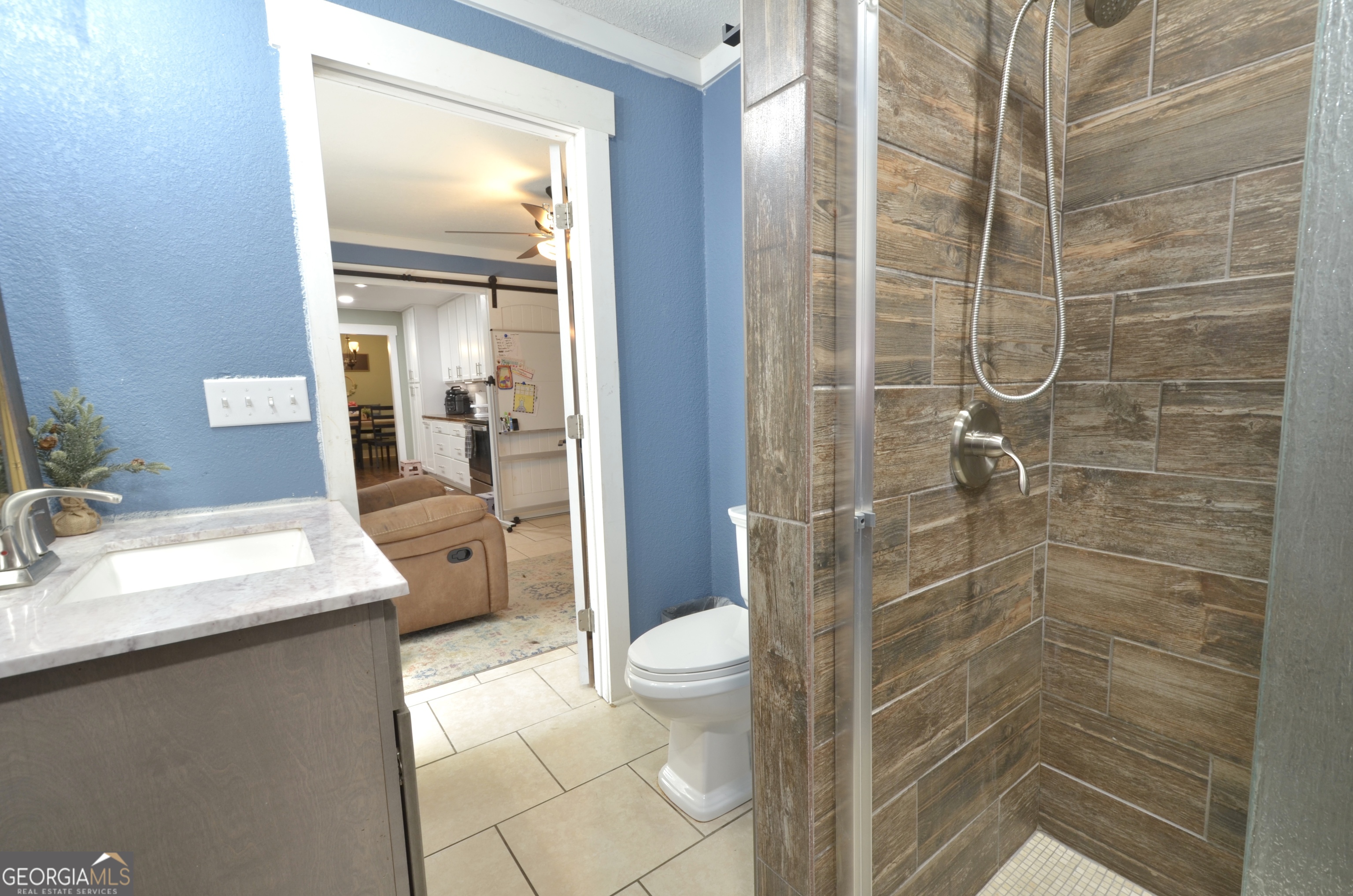 228 Legion Drive Eastman, GA 31023 - Photo 26 of 37 a bathroom with a granite countertop sink a toilet and shower
