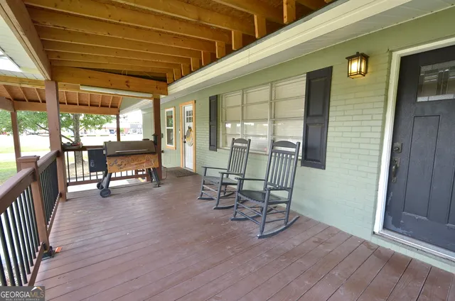 a view of a room with wooden floor and furniture