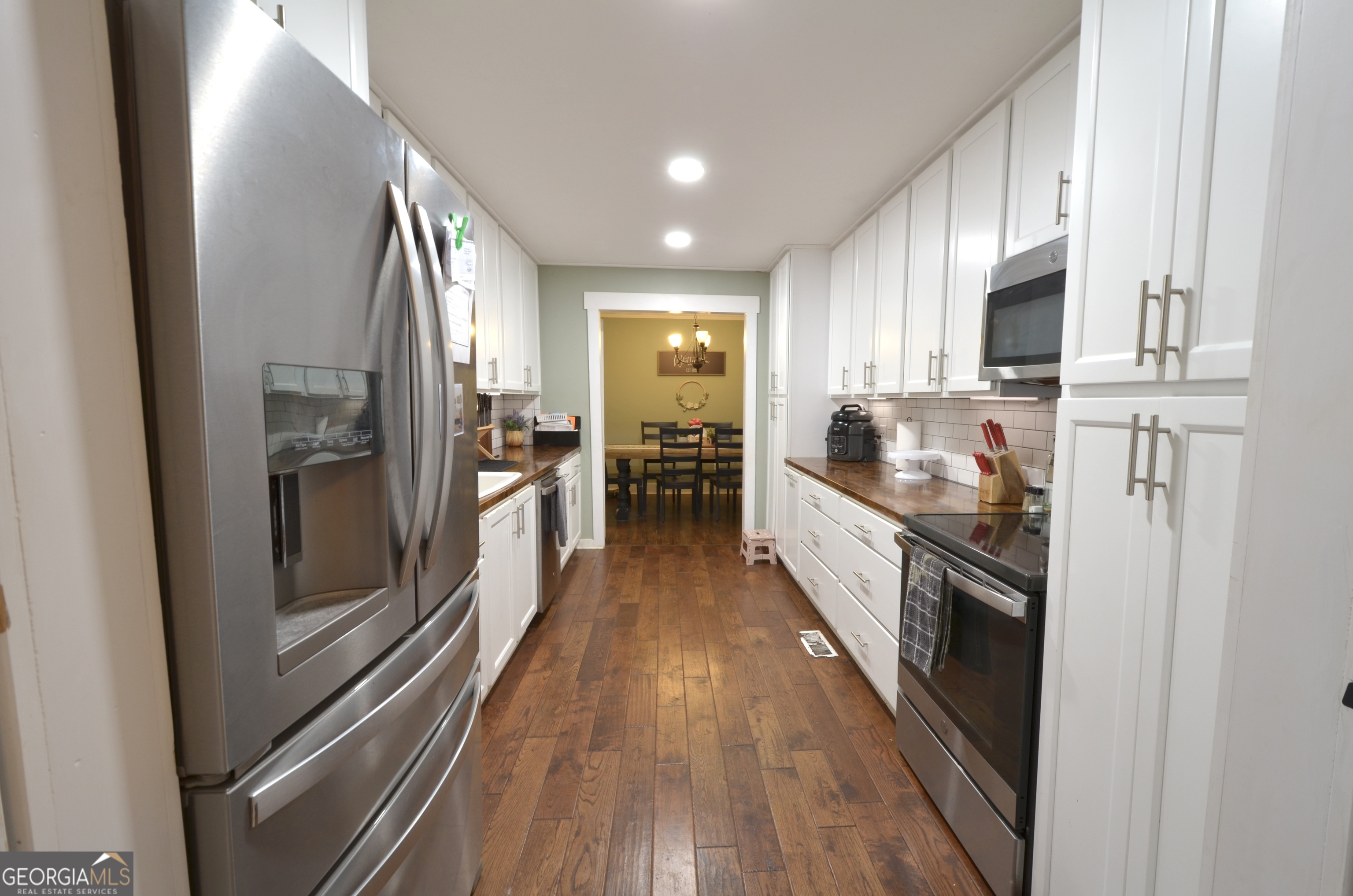 228 Legion Drive Eastman, GA 31023 - Photo 8 of 37 a large kitchen with kitchen island wooden floor and stainless steel appliances