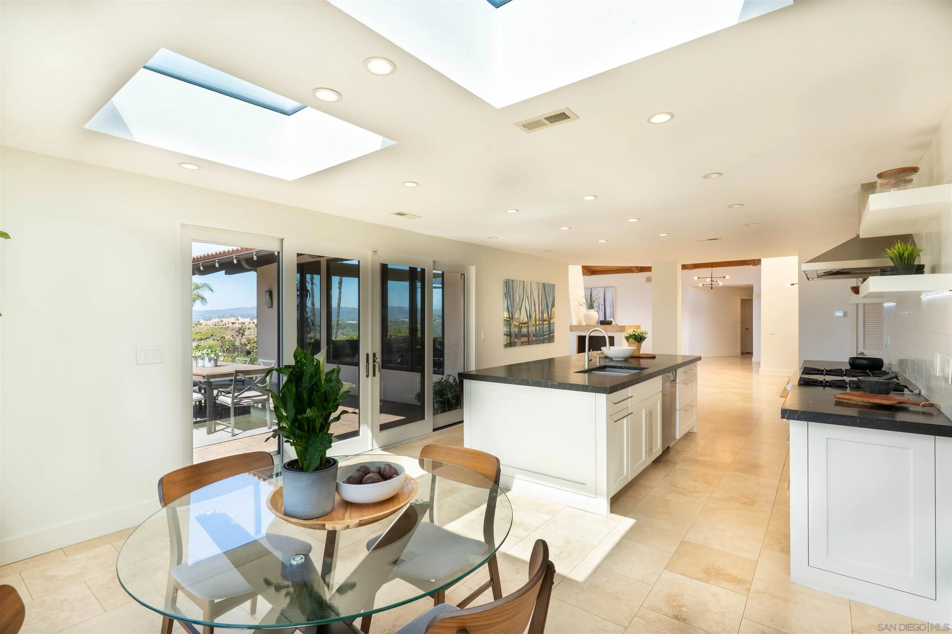 30410 Calle La Reina Bonsall, CA 92003 - Photo 13 of 54 a large kitchen with a table and chairs
