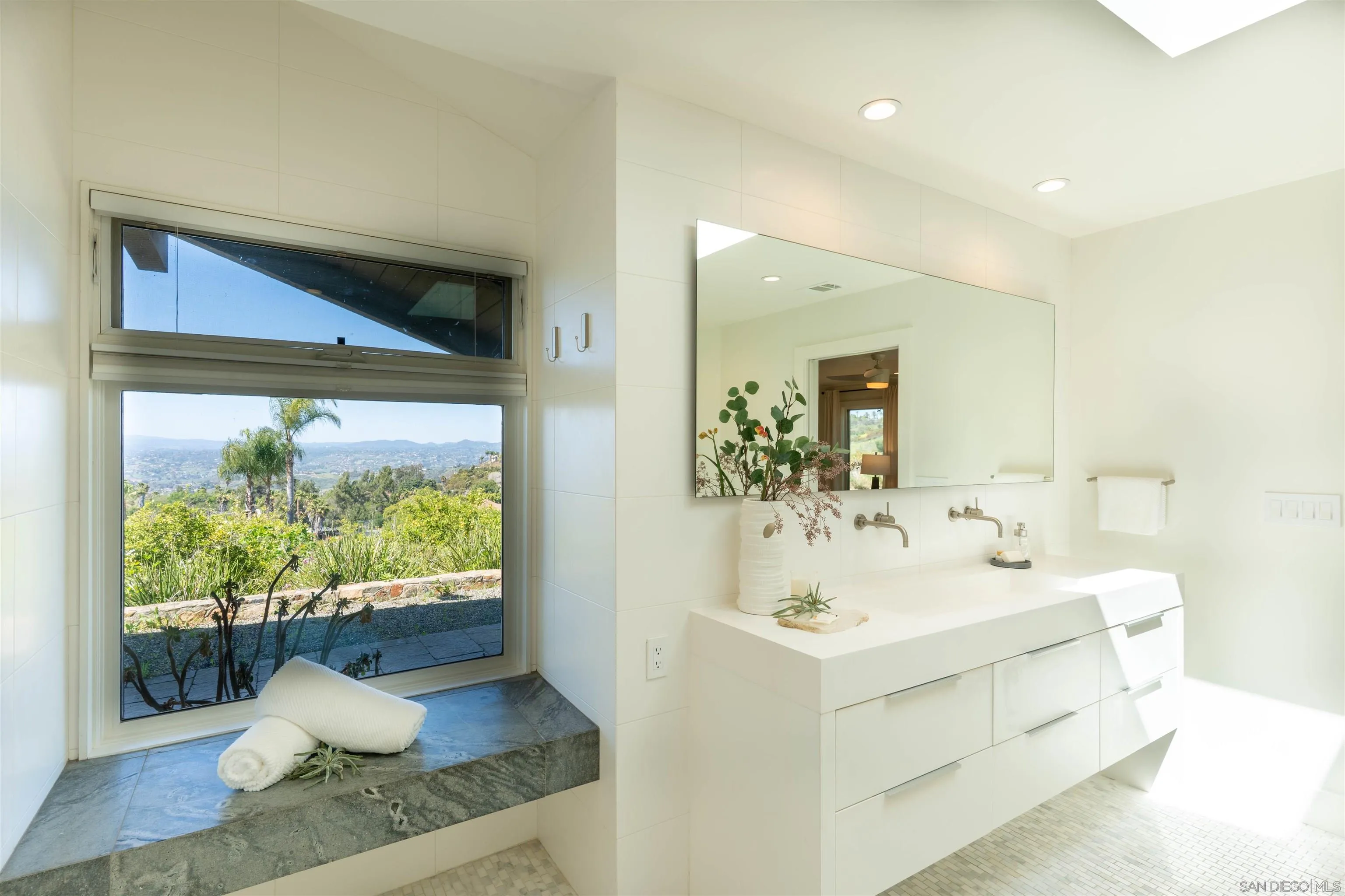 30410 Calle La Reina Bonsall, CA 92003 - Photo 19 of 54 a bathroom with a sink mirror and vanity