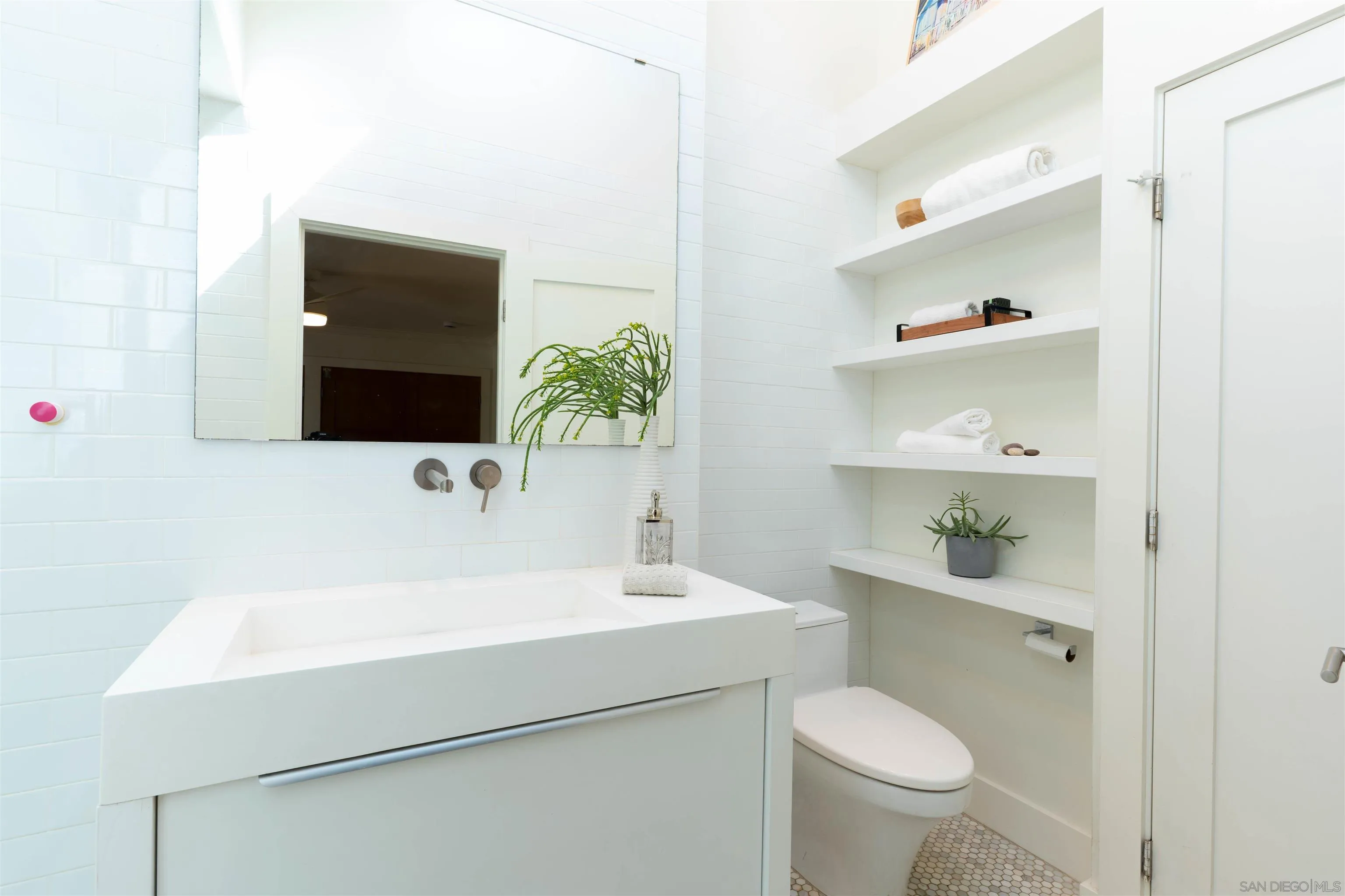30410 Calle La Reina Bonsall, CA 92003 - Photo 28 of 54 a bathroom with a sink a toilet and a mirror