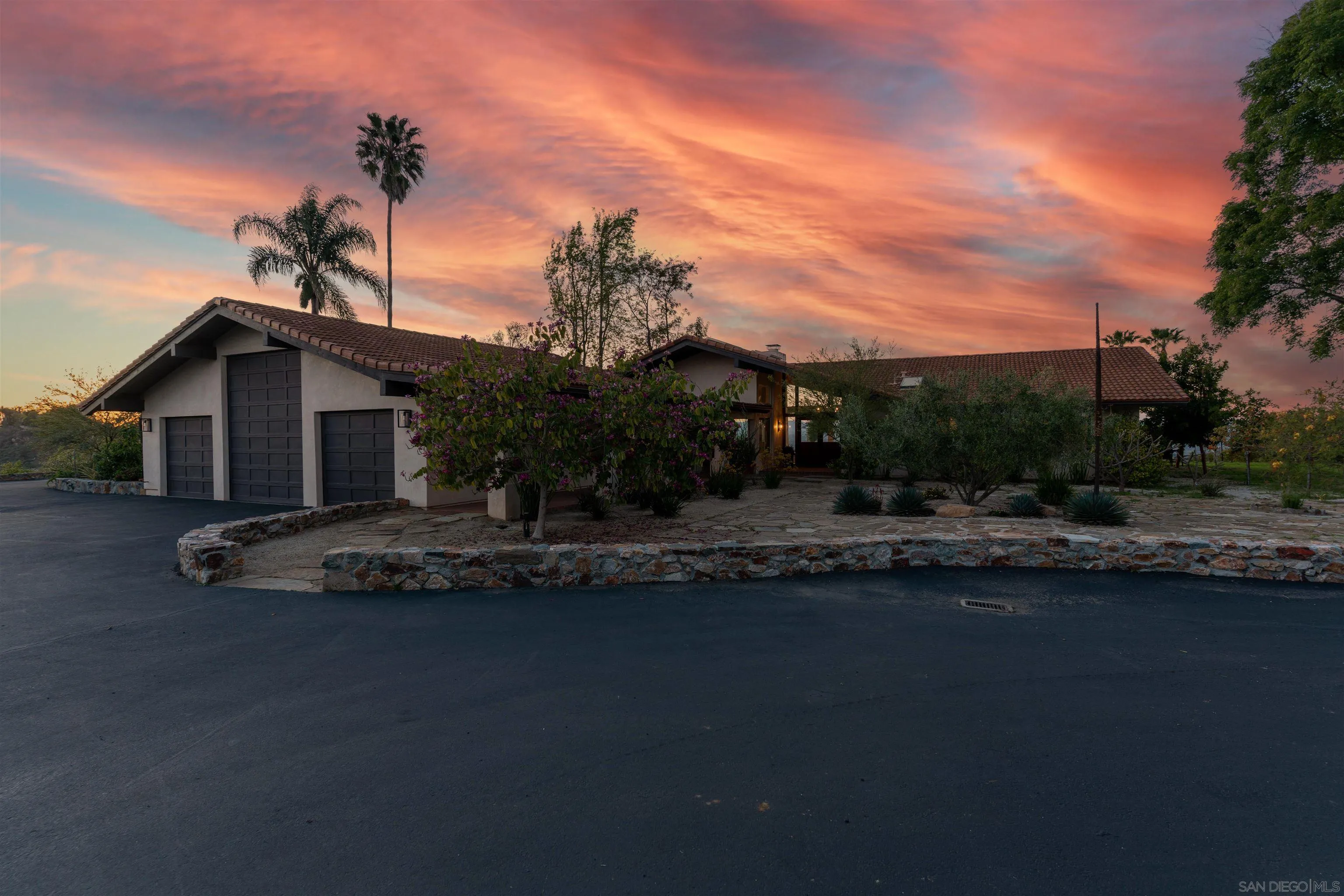 30410 Calle La Reina Bonsall, CA 92003 - Photo 38 of 54 a front view of a house with a garden and yard