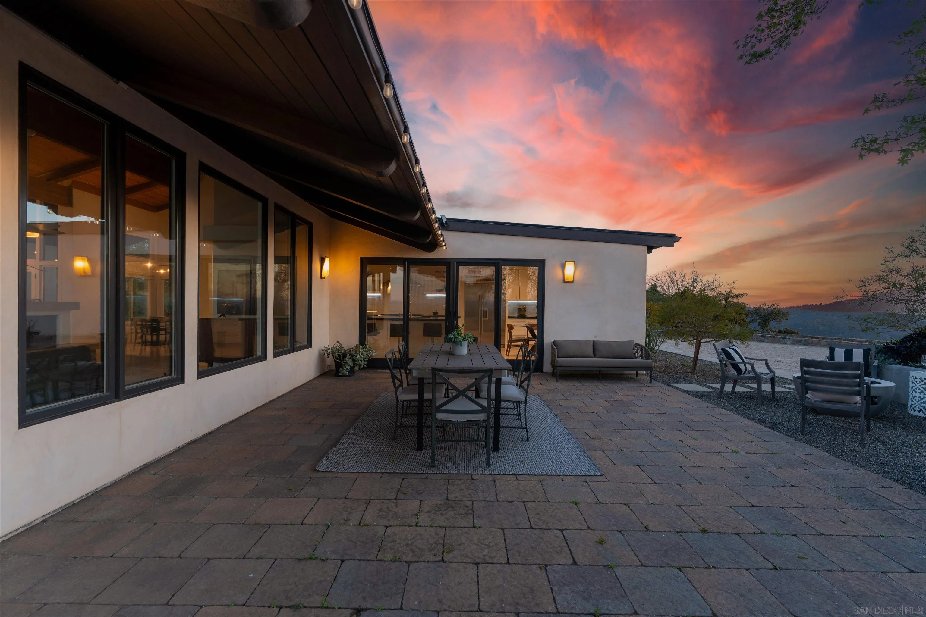 30410 Calle La Reina Bonsall, CA 92003 - Photo 45 of 54 a view of a patio with table and chairs and floor to ceiling window