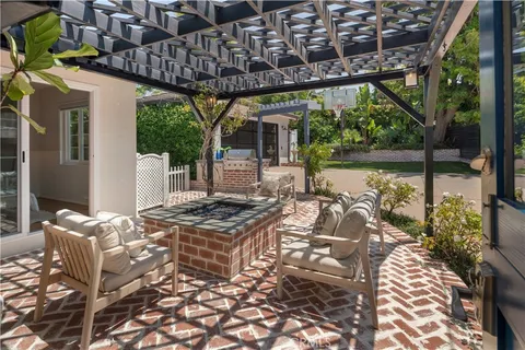 a view of a patio with table and chairs near a yard