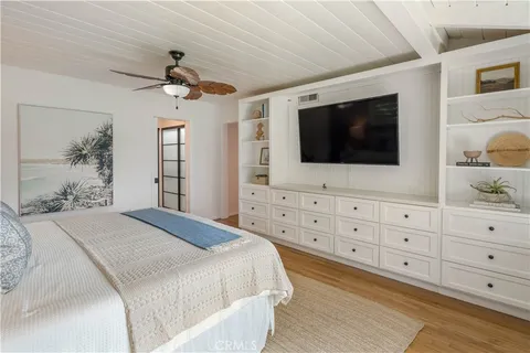 a bedroom with a large bed and a flat screen tv
