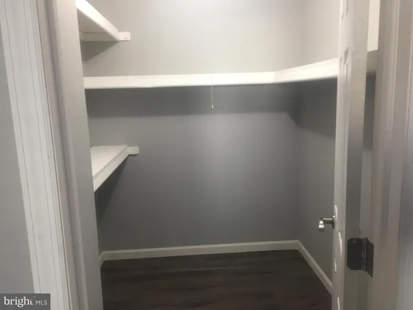 an empty room with wooden floor and door