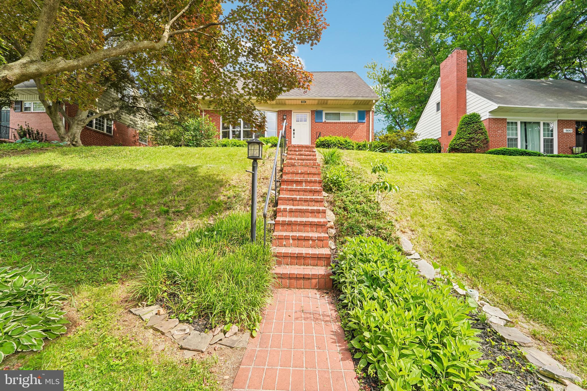 6640 Loch Hill Road Baltimore, MD 21239 - Photo 1 of 35 a front view of a house with a yard and trees