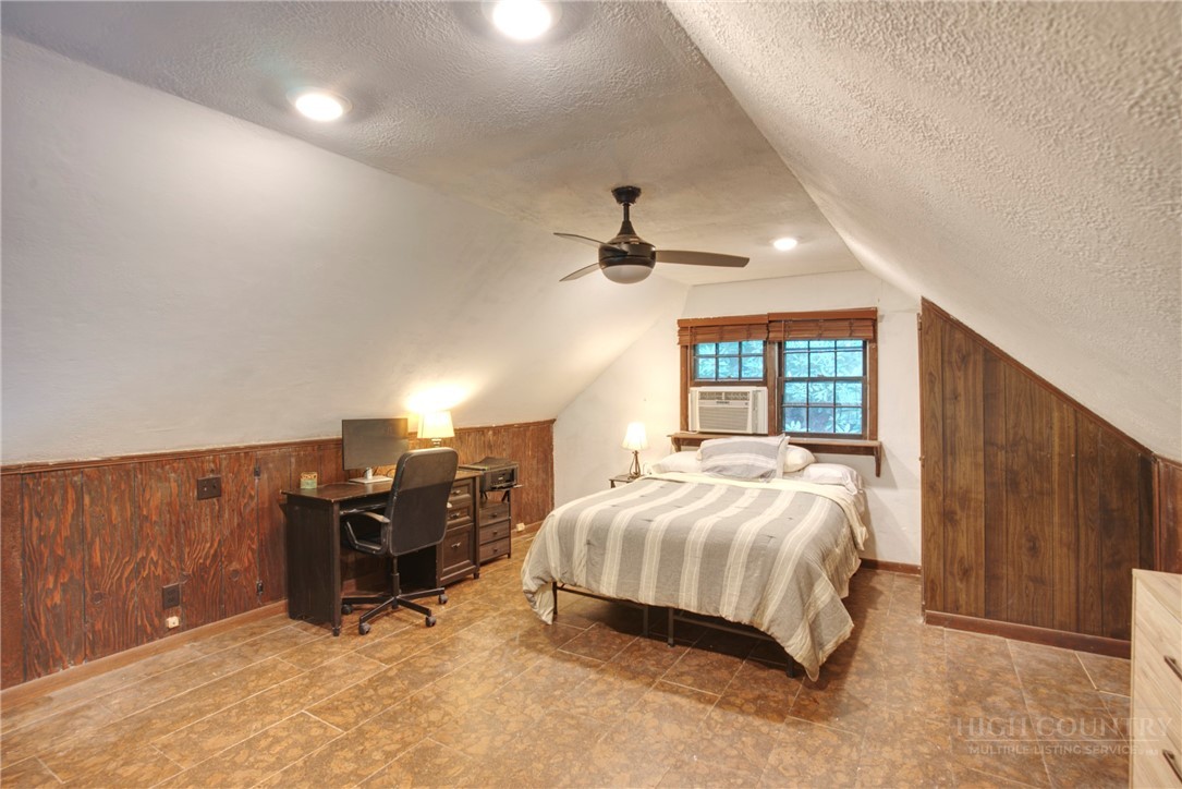 9440 Blackberry Road Lenoir, NC 28645 - Photo 20 of 30 a bedroom with a bed and wooden floor