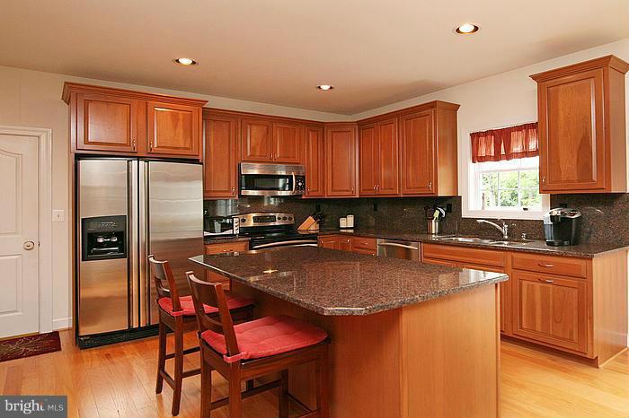 4830 Roop Road Mount Airy, MD 21771 - Photo 2 of 30 a kitchen with stainless steel appliances granite countertop a stove a sink dishwasher a refrigerator and a microwave