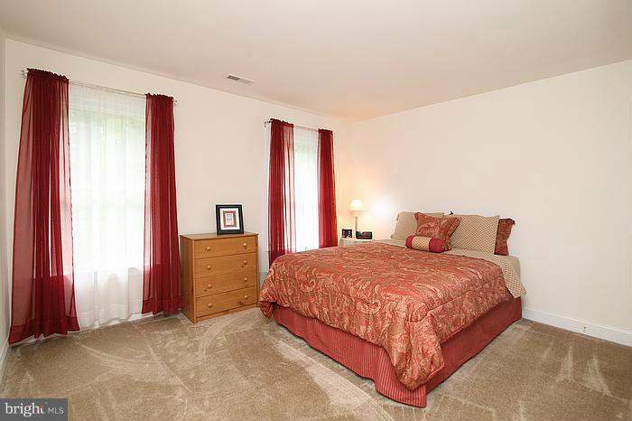 4830 Roop Road Mount Airy, MD 21771 - Photo 14 of 30 a bedroom with a bed and a dresser