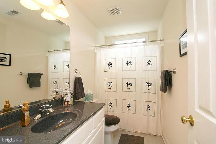 4830 Roop Road Mount Airy, MD 21771 - Photo 16 of 30 a bathroom with a sink vanity mirror and shower