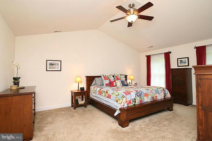 4830 Roop Road Mount Airy, MD 21771 - Photo 20 of 30 a bedroom with a bed and a chandelier