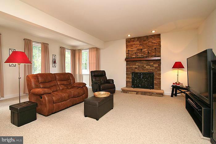 4830 Roop Road Mount Airy, MD 21771 - Photo 4 of 30 a living room with furniture flat screen tv and a fireplace