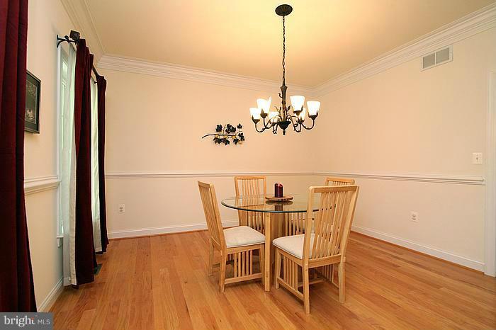 4830 Roop Road Mount Airy, MD 21771 - Photo 6 of 30 a view of a dining room with furniture wooden floor and chandelier