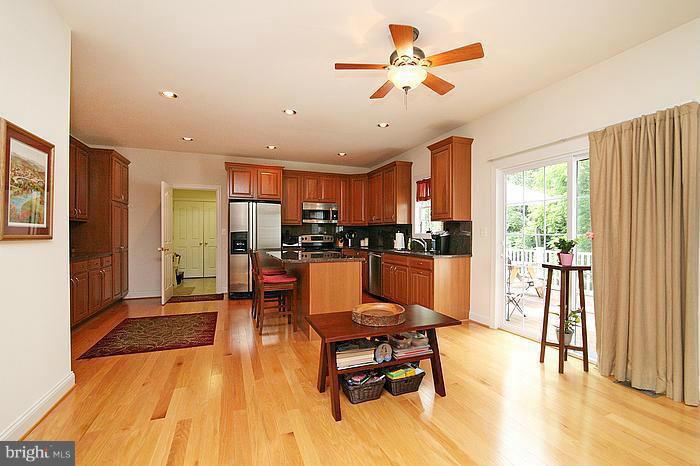 4830 Roop Road Mount Airy, MD 21771 - Photo 10 of 30 a living room with stainless steel appliances kitchen island granite countertop furniture and a dining table