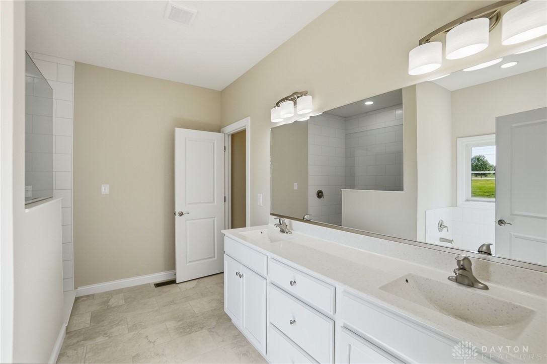 4600 Beal Road Franklin, OH 45005 - Photo 18 of 42 This spacious primary bathroom offers a dual vanity, shower, and separate soaking tub.