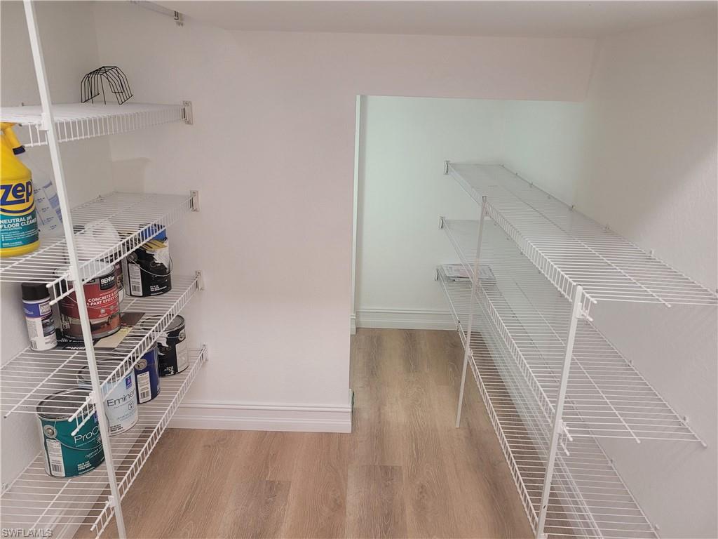 15618 Summit Pl Circle, Unit 396 Naples, FL 34119 - Photo 11 of 41 a view of a room with wooden floor and staircase