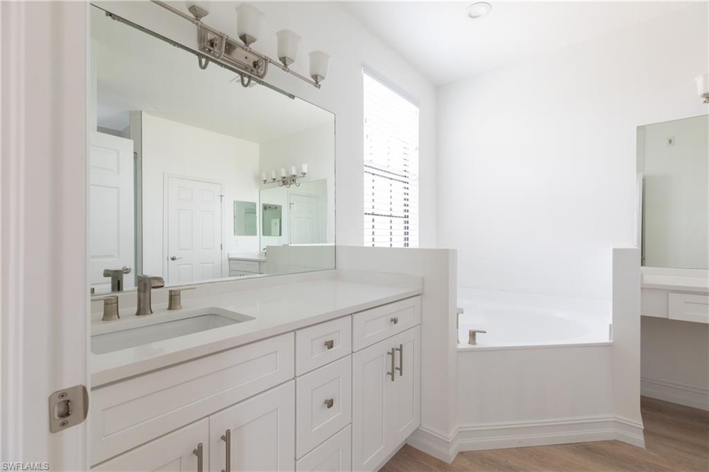 15618 Summit Pl Circle, Unit 396 Naples, FL 34119 - Photo 20 of 41 a bathroom with a sink and a mirror