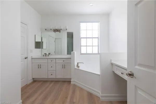a bathroom with a granite countertop sink a toilet and shower