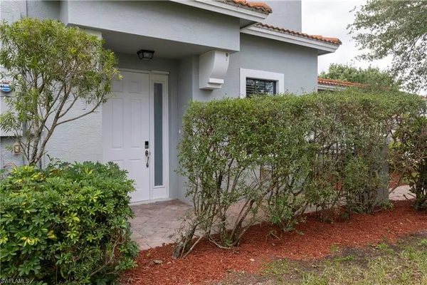 a front view of house with yard and trees