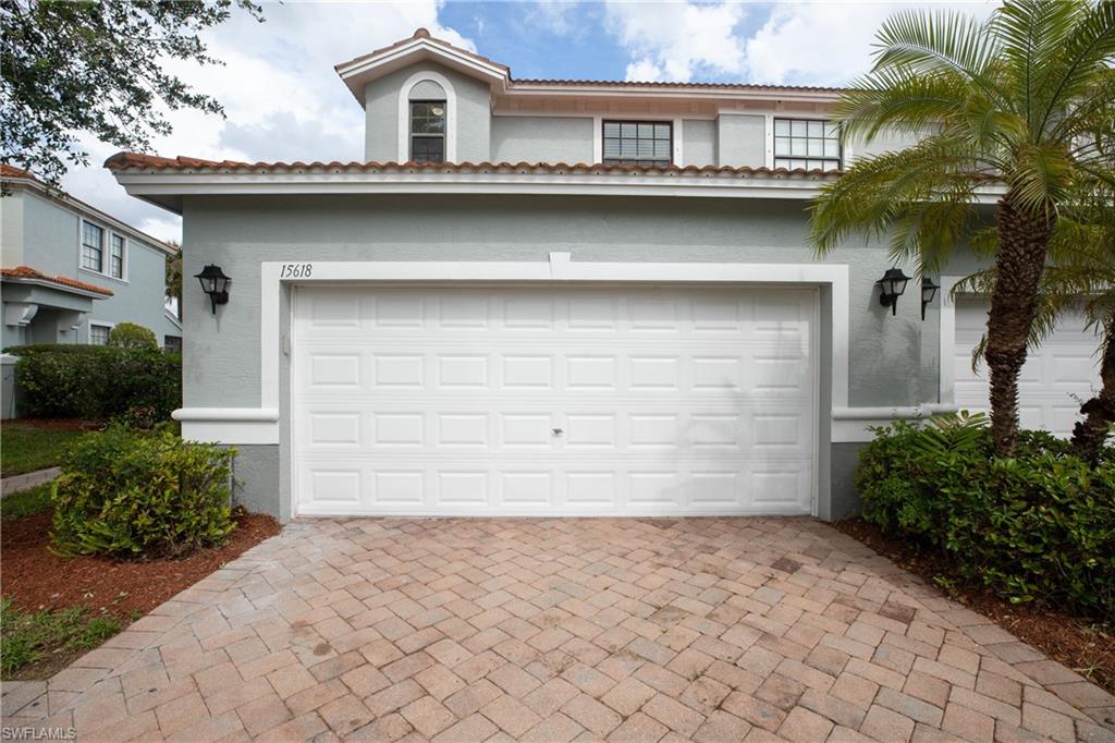 15618 Summit Pl Circle, Unit 396 Naples, FL 34119 - Photo 29 of 41 a front view of a house with a yard