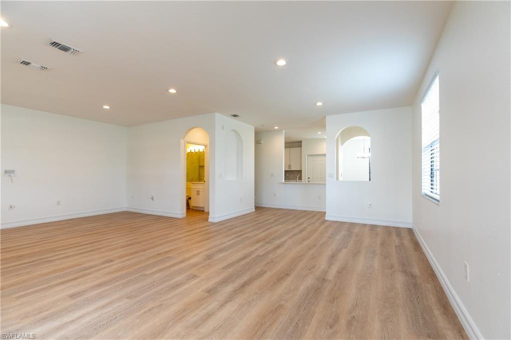 15618 Summit Pl Circle, Unit 396 Naples, FL 34119 - Photo 3 of 41 a view of empty room with wooden floor and window