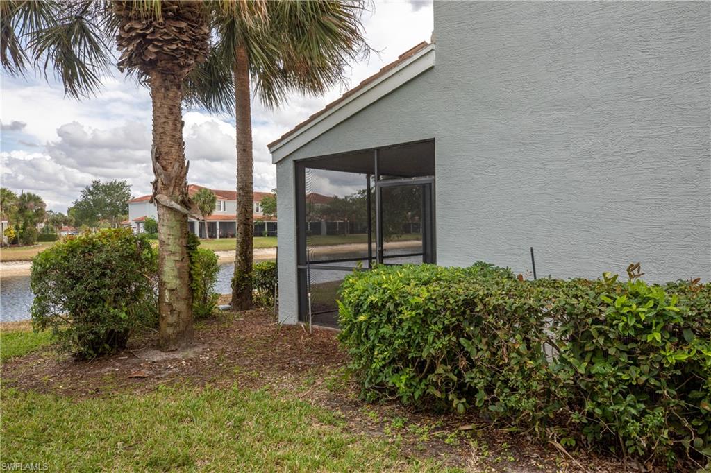 15618 Summit Pl Circle, Unit 396 Naples, FL 34119 - Photo 32 of 41 front view of a house with a garden